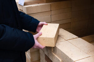 person looking at clinker bricks